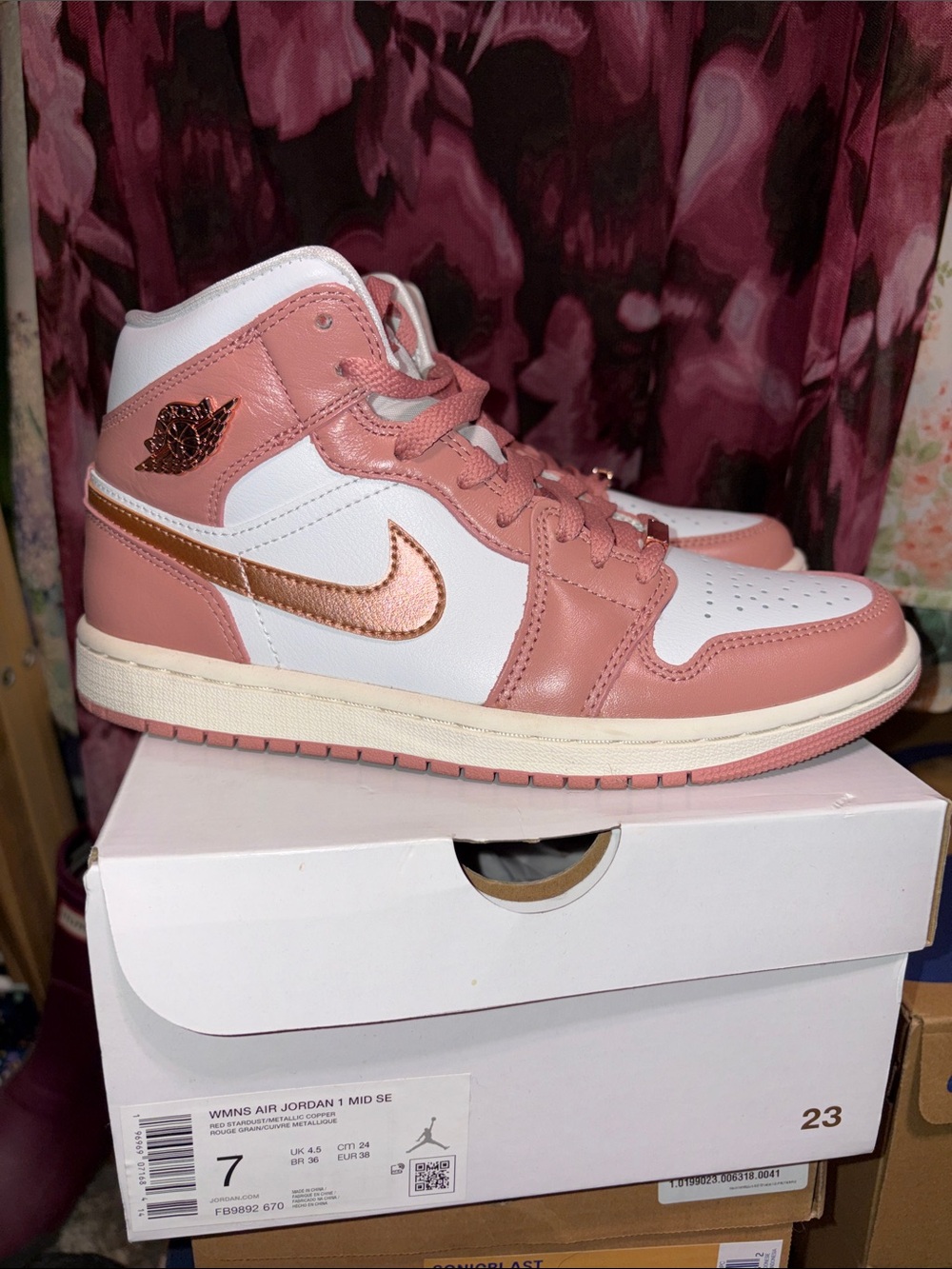 Jordan Women’s Pink and White High Top Sneakers with Metallic Rose Swoosh